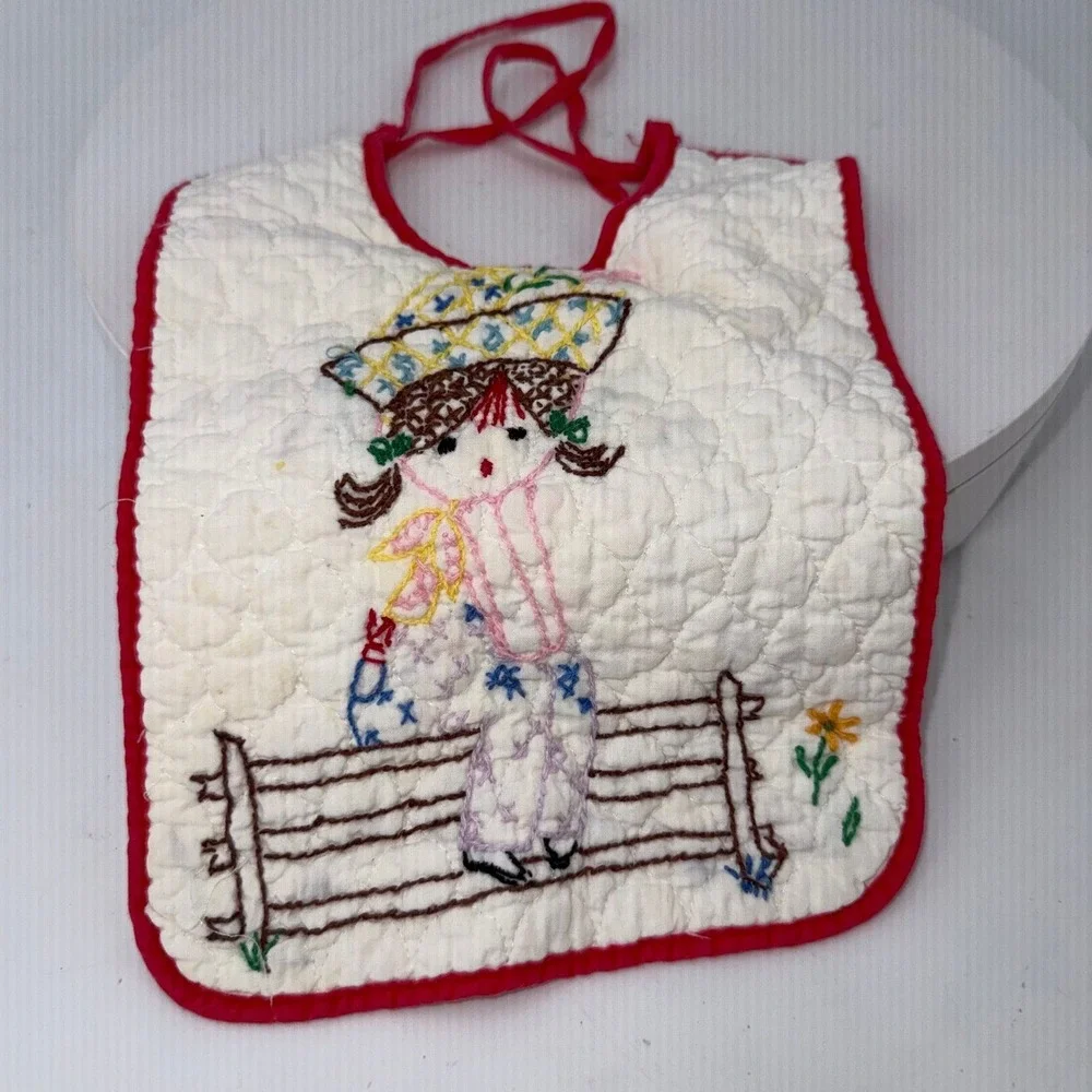 Vtg handmade quilted baby bib embroidered girl in a hat sitting on a fence
